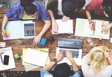 Students with graphs on their computers