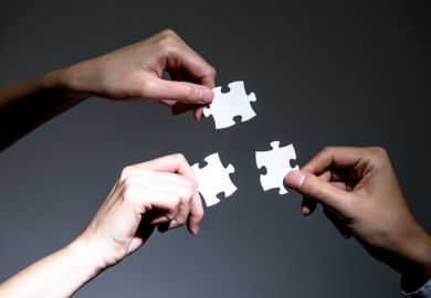 People holding three jigsaw pieces, symbolising the Adelaide university merger