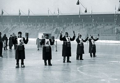 Judges hold up their score cards on the ice