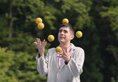 Man juggling several balls, illustrating the struggle to balance the competing pressures of teaching and studying for PhD studentships.