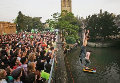 Oxford University students jump into the river from Magdalen Bridge Oxford University students jump into the river from Magdalen Bridge