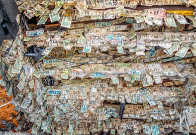 Key West, USA - January 25, 2021 Willie T's famous bar pub with many hanging US dollar bills banknotes on ceiling inside of restaurant