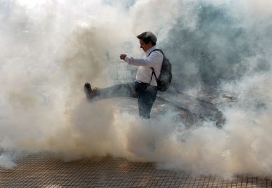 man kicks cloud of smoke