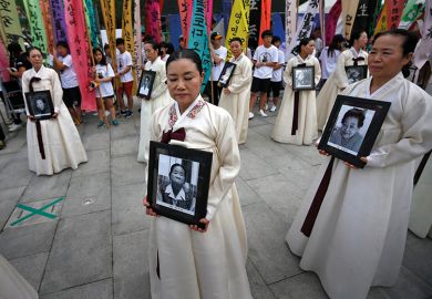 Protesters carry portraits of Korean women who were made sex slaves during Second World War