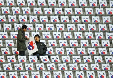 South Koreans sit in seats with the South Korean national flag at the Seoul World Cup Stadium in Seoul South Koreans sit in seats with the South Korean national flag at the Seoul World Cup Stadium in Seoul