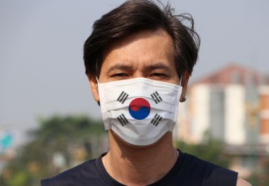 Man wearing a mask with the South Korean flag