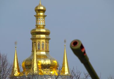 A Kyiv church with a tank gun in the foreground, illustrating the war in Ukraine