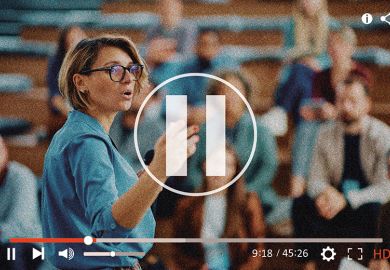 Lecturer view through camera with pause button