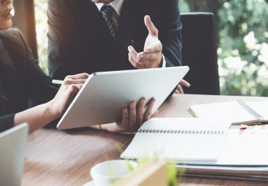 A lawyer offers advice to a student A lawyer offers advice to a student