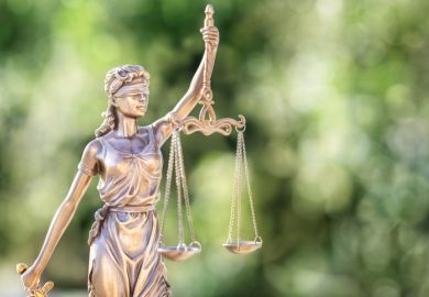 Legal and law concept statue of Lady Justice with scales of justice and green background