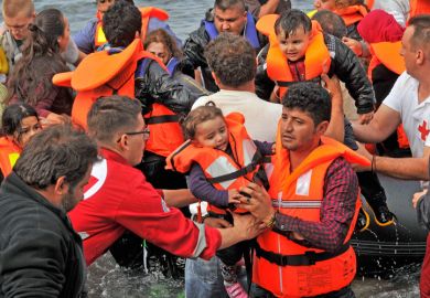 Volunteer rescuers helping refugees on Lesvos in Greece Volunteer rescuers helping refugees on Lesvos in Greece