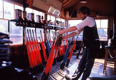 A signalman pulling levers