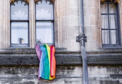 LGBT rainbow flag hanging outside university building LGBT rainbow flag hanging outside university building
