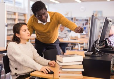 A librarian helping a student A librarian helping a student