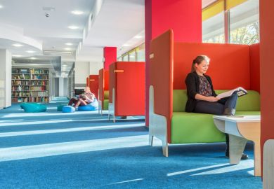 Library with individual study area with red partition and green sofa
