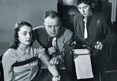 Two researchers conducting a lie detector test on a young woman
