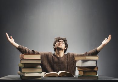 A man with a pile of books, symbolising Lifelong learning