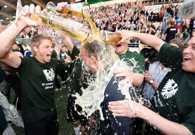 Men pouring beer over each other