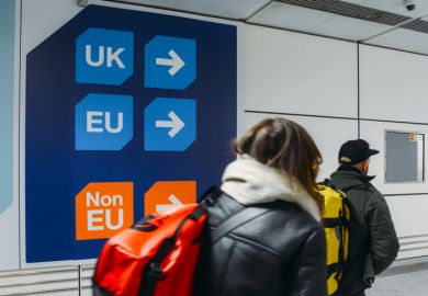 London Gatwick, March 2nd, 2018 Passengers walks past sign prior to immigration control pass a sign pointing towards queues for UK, EU and Non-EU passport holders. In April 2019, UK is set to leave the European Union - Brexit theme