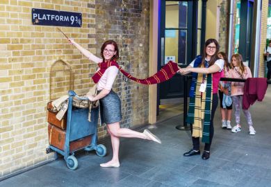 London UK - June 16 2016 Platform 9 three-quarter at Kings Cross Station with unidentified people. The platform is a fictive one from Harry Potter movies installed at Kings Cross for tourists