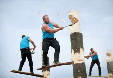 lumberjacks chop tree trunks in a lumberjack competition to illustrate University presidents are ‘driven by fear’ with him having to make cuts
