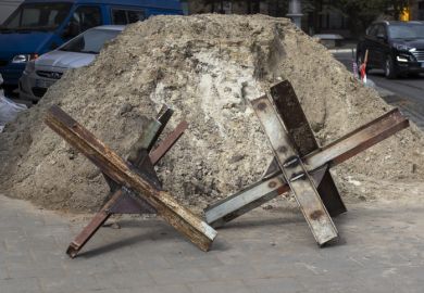 Lviv, Ukraine - March 10, 2022. Daily life during the war. Czech hedgehogs (anti-tank obstacles) on the city street.