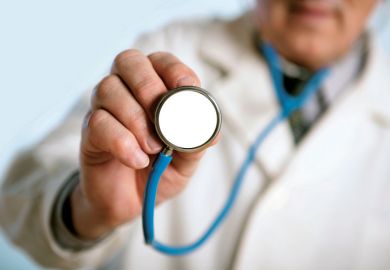 Male doctor holding stethoscope