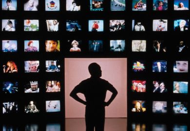 Male silhouette facing wall of television screens Male silhouette facing wall of television screens