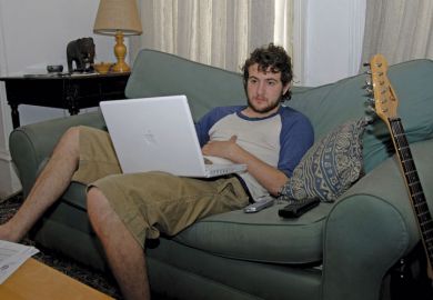 Male student using Apple laptop