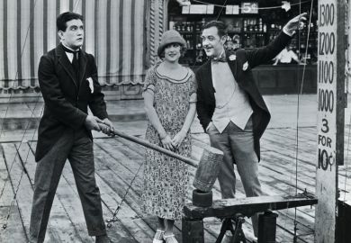 Man attempting strength test at amusement park