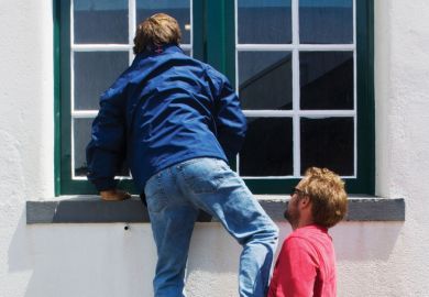 Man being lifted up to look through window