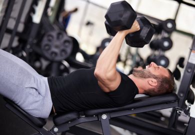 Man bench pressing with dumbbells Man bench pressing with dumbbells
