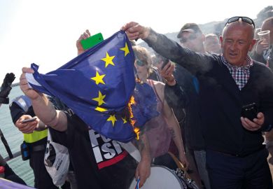Man burning European Union (EU) flag Man burning European Union (EU) flag