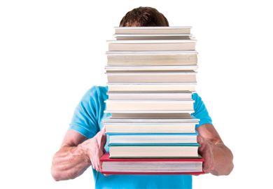 b Man carrying pile of books with face hidden