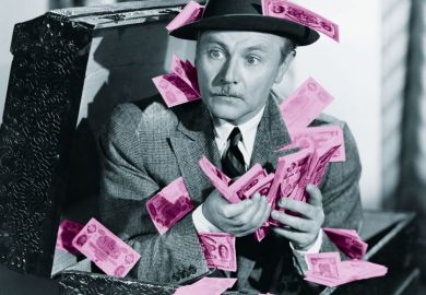 Man crouching in box full of cash