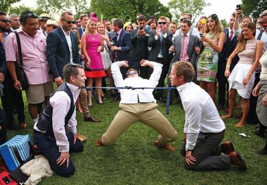 Man doing limbo under ties