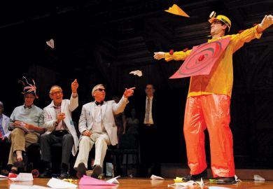 Man dressed as target hit by thrown paper aeroplanes