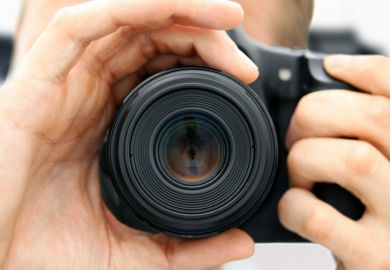 Man focussing camera lens