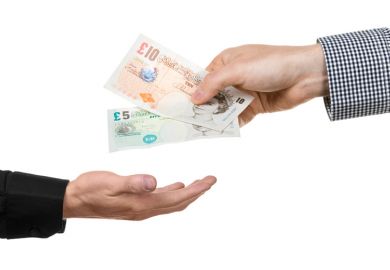 Man handing over British bank notes Man handing over British bank notes