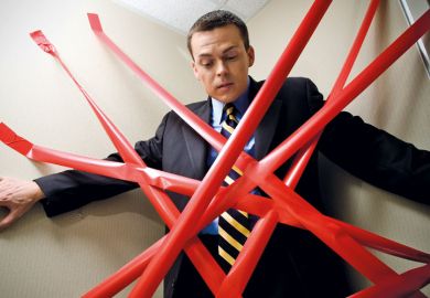 Man held back by red tape Man held back by red tape