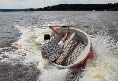 Man holding onto capsizing boat
