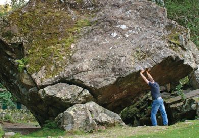 Man holding up rock