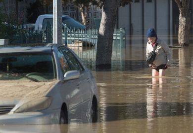 man in flood waters California