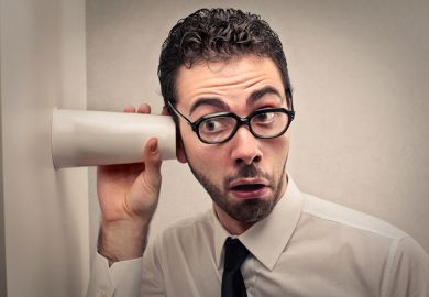 Man listening through wall with cup