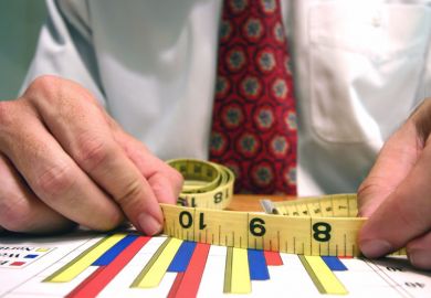 Man measuring bar graphs with tape measure Man measuring bar graphs with tape measure