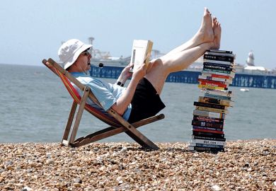 Man on beach reading