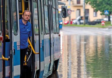 Man on tram stuck on flooded street, Wroclaw, Poland Man on tram stuck on flooded street, Wroclaw, Poland