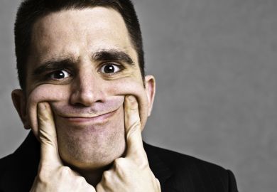 Man pulling face into fake smile