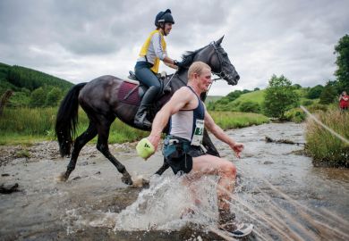 Man racing horse across shallow river Man racing horse across shallow river