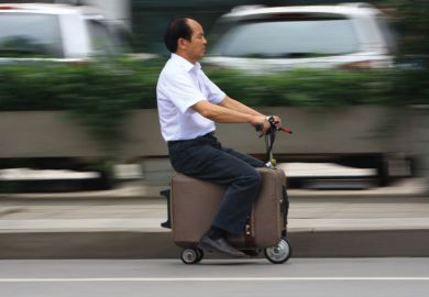 Man rides on electric suitcase Man rides on electric suitcase